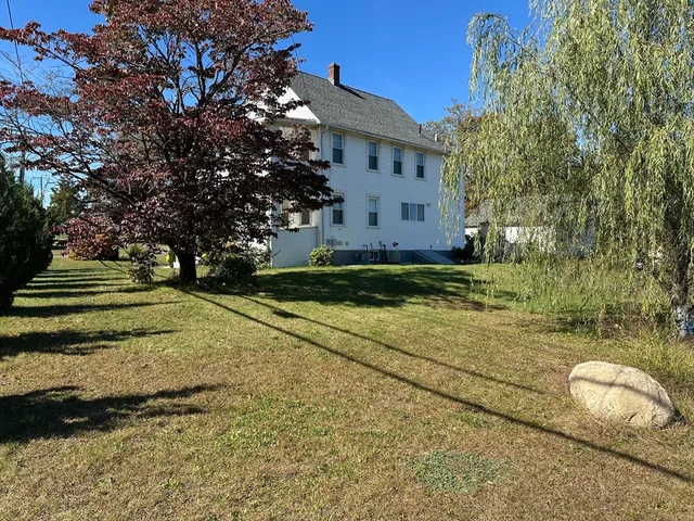 a view of a yard with large trees