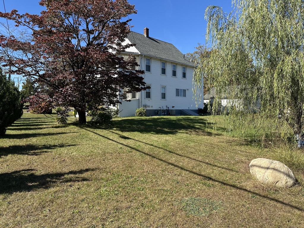 712 Cooper Street Agawam, MA 01001 - Photo 24 of 26 a view of a yard with large trees