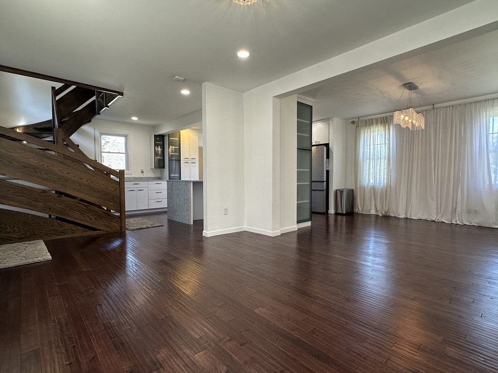 712 Cooper Street Agawam, MA 01001 - Photo 5 of 26 an empty room with wooden floor and windows