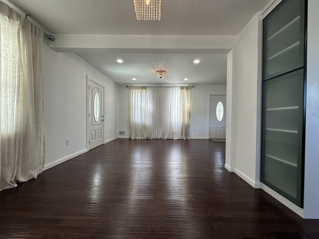 712 Cooper Street Agawam, MA 01001 - Photo 6 of 26 an empty room with wooden floor and windows