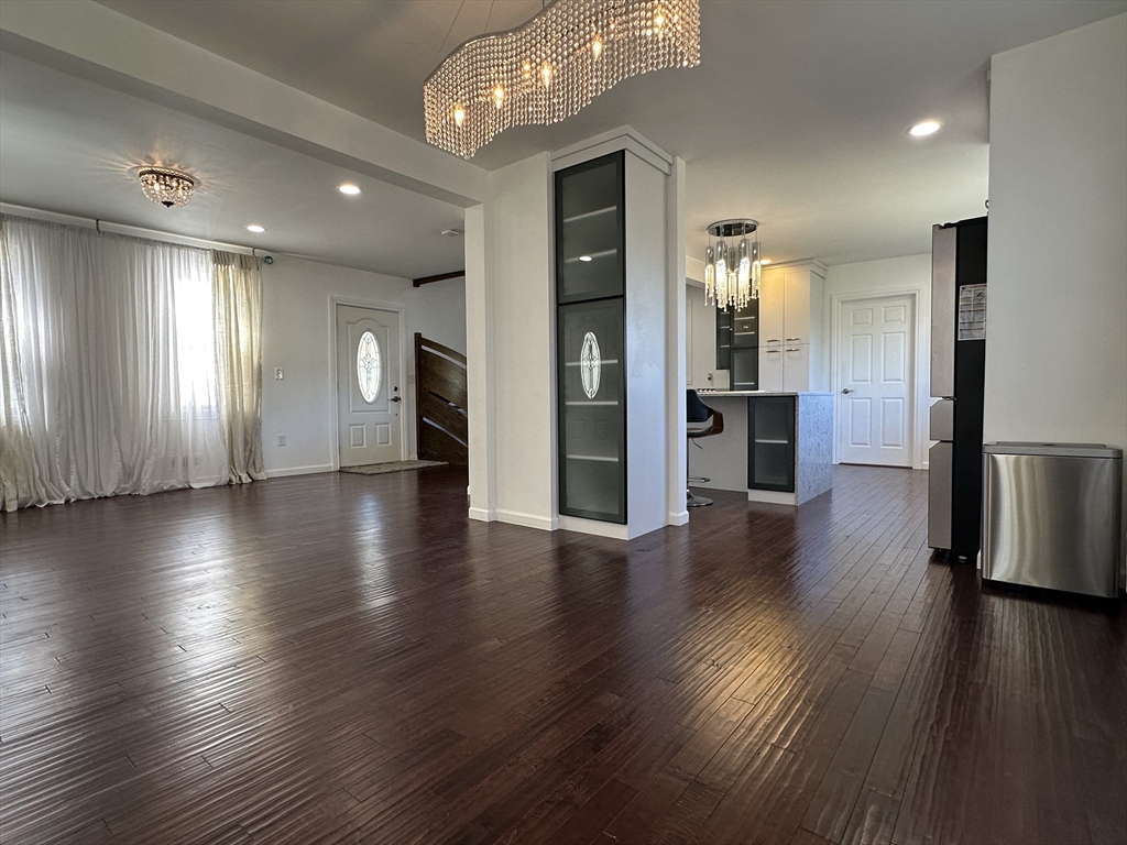 712 Cooper Street Agawam, MA 01001 - Photo 7 of 26 an empty room with wooden floor and windows