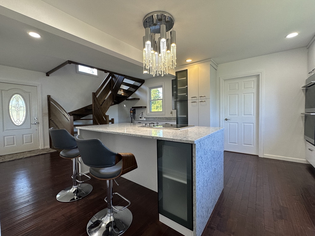 712 Cooper Street Agawam, MA 01001 - Photo 8 of 26 a kitchen with granite countertop a sink cabinets and wooden floor