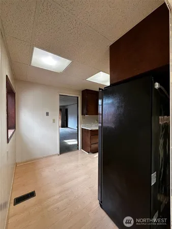a view of a hallway with a kitchen