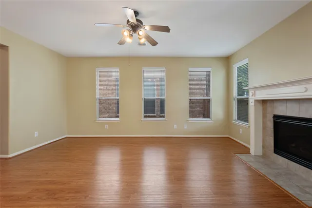 a view of a room with wooden floor and white walls