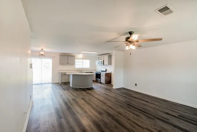 a view of a kitchen with a sink and cabinets