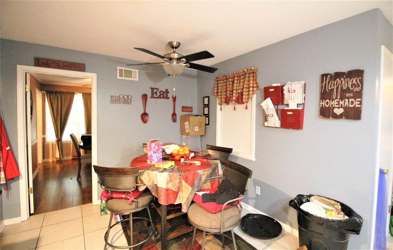 2992 Charles Bryan Road Bartlett, TN 38134 - Photo 11 of 18 a dining room with furniture and wooden floor