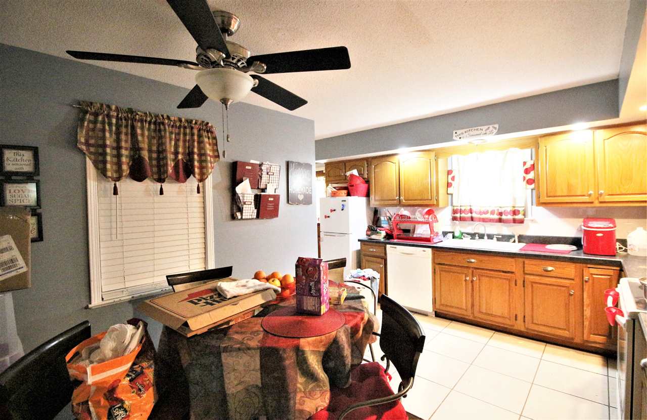 2992 Charles Bryan Road Bartlett, TN 38134 - Photo 12 of 18 a kitchen with stainless steel appliances kitchen island granite countertop a table chairs in it and wooden floor
