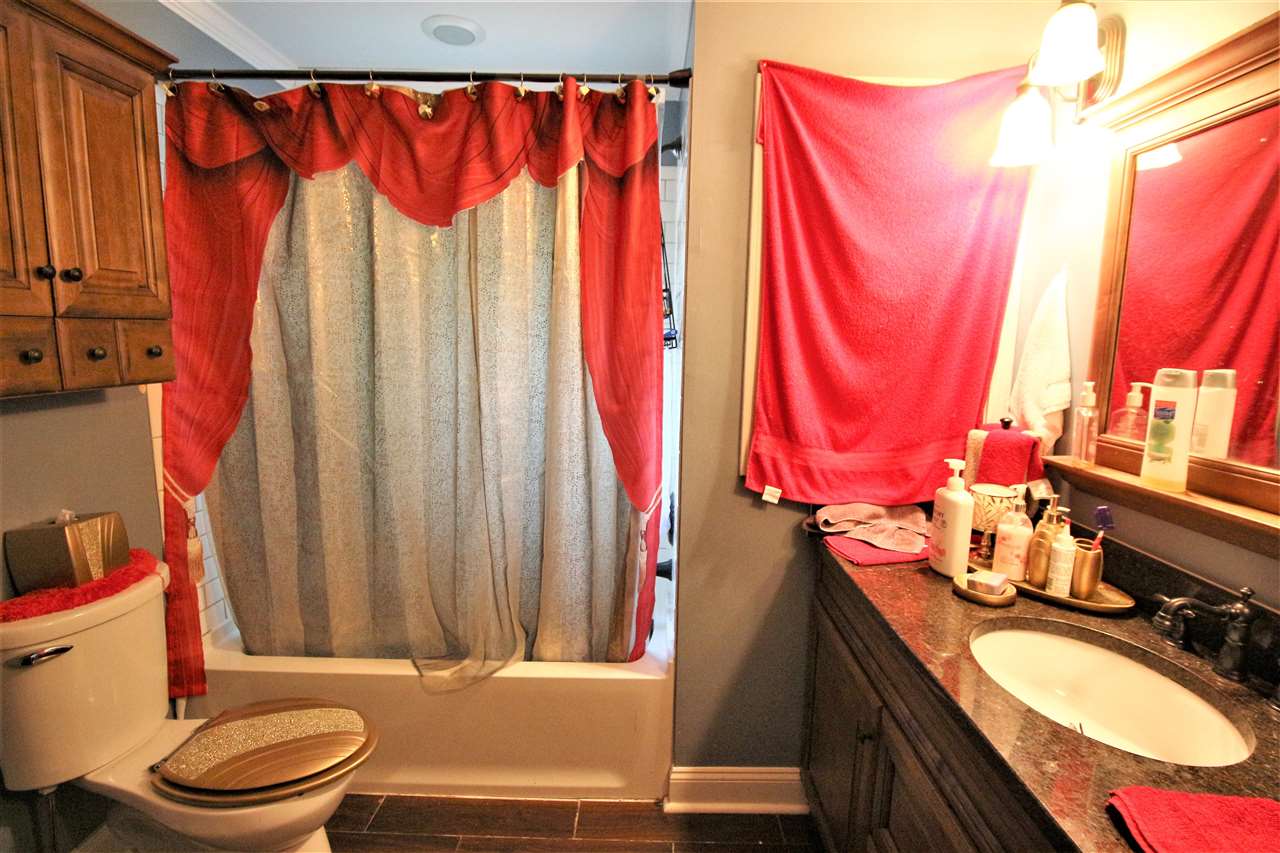 2992 Charles Bryan Road Bartlett, TN 38134 - Photo 13 of 18 a bathroom with a granite countertop bathtub sink vanity mirror and toilet