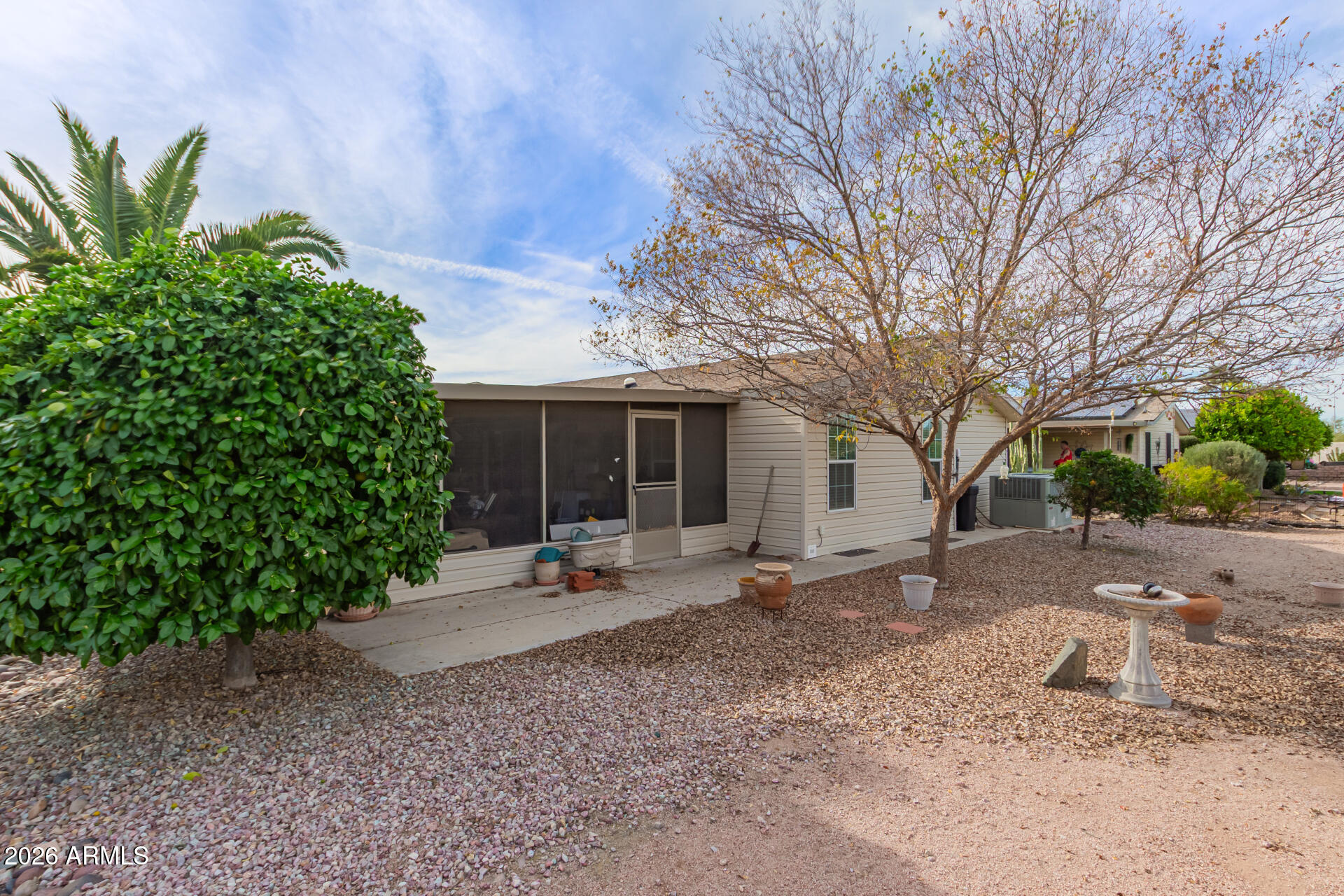 3301 South Goldfield Road, Unit 4028 Apache Junction, AZ 85119 - Photo 30 of 43 a view of a house with a yard and large tree