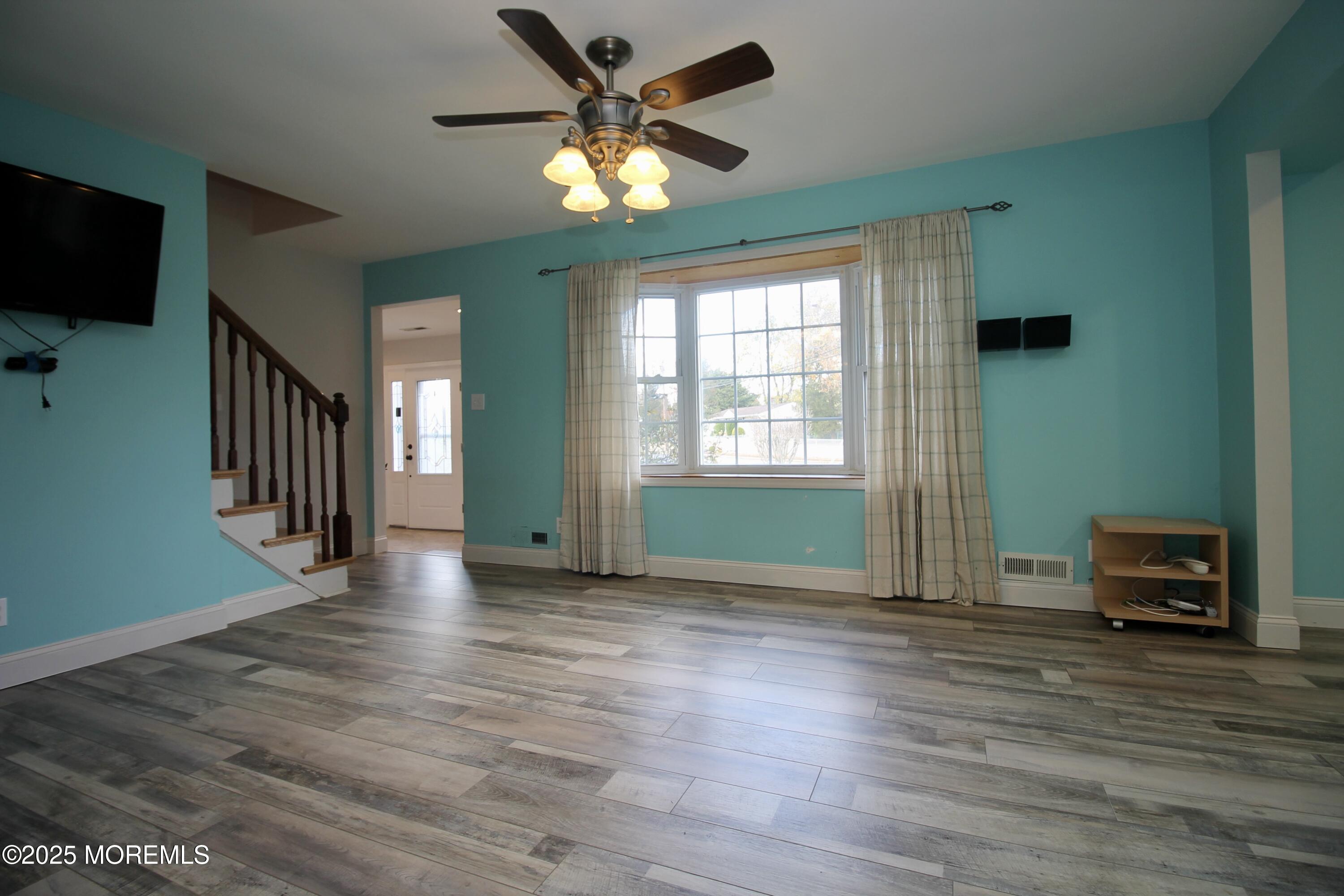 16 Maple Lane Howell, NJ 07731 - Photo 12 of 55 an empty room with wooden floor a ceiling fan and a window