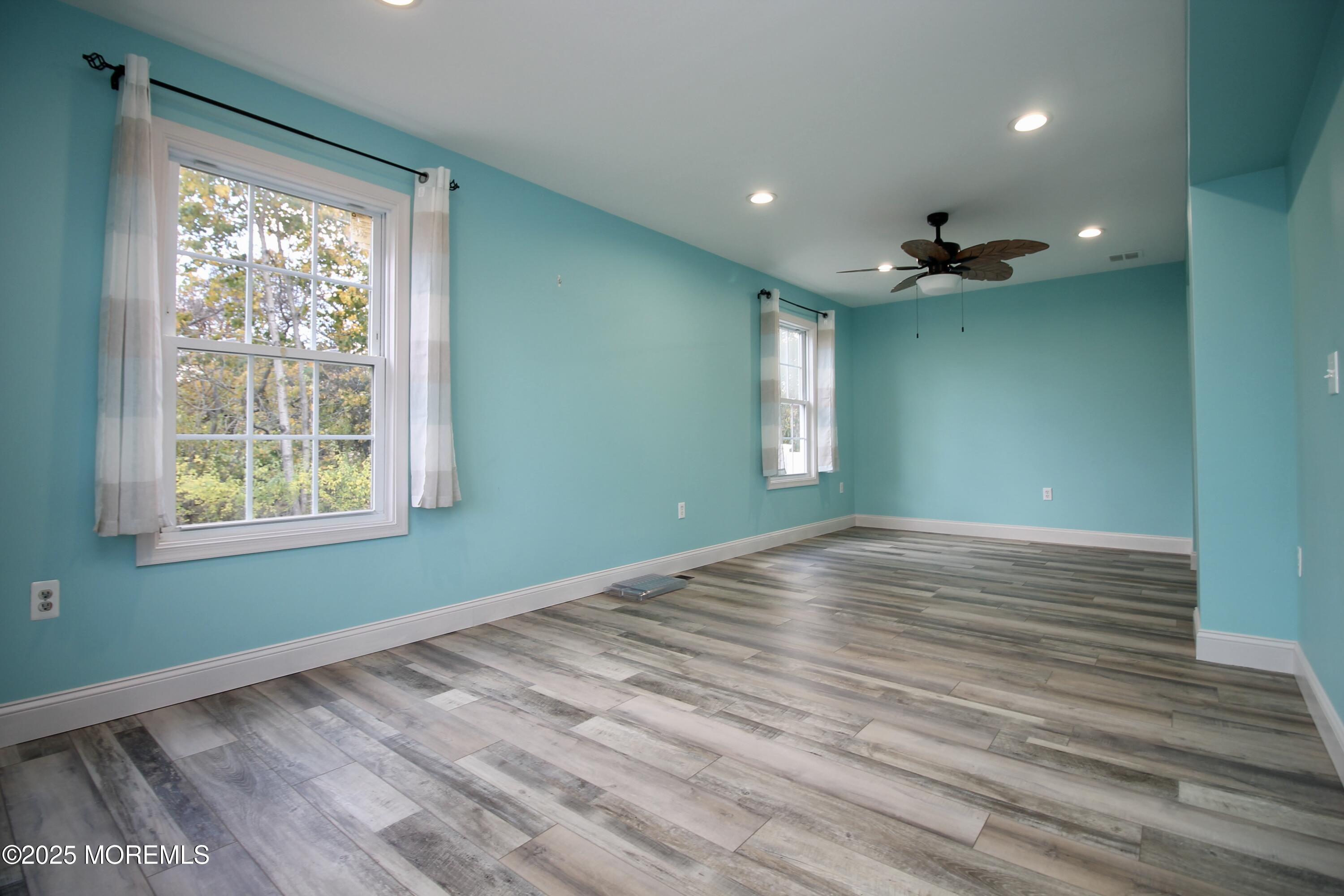 16 Maple Lane Howell, NJ 07731 - Photo 13 of 55 a view of empty room with wooden floor and fan