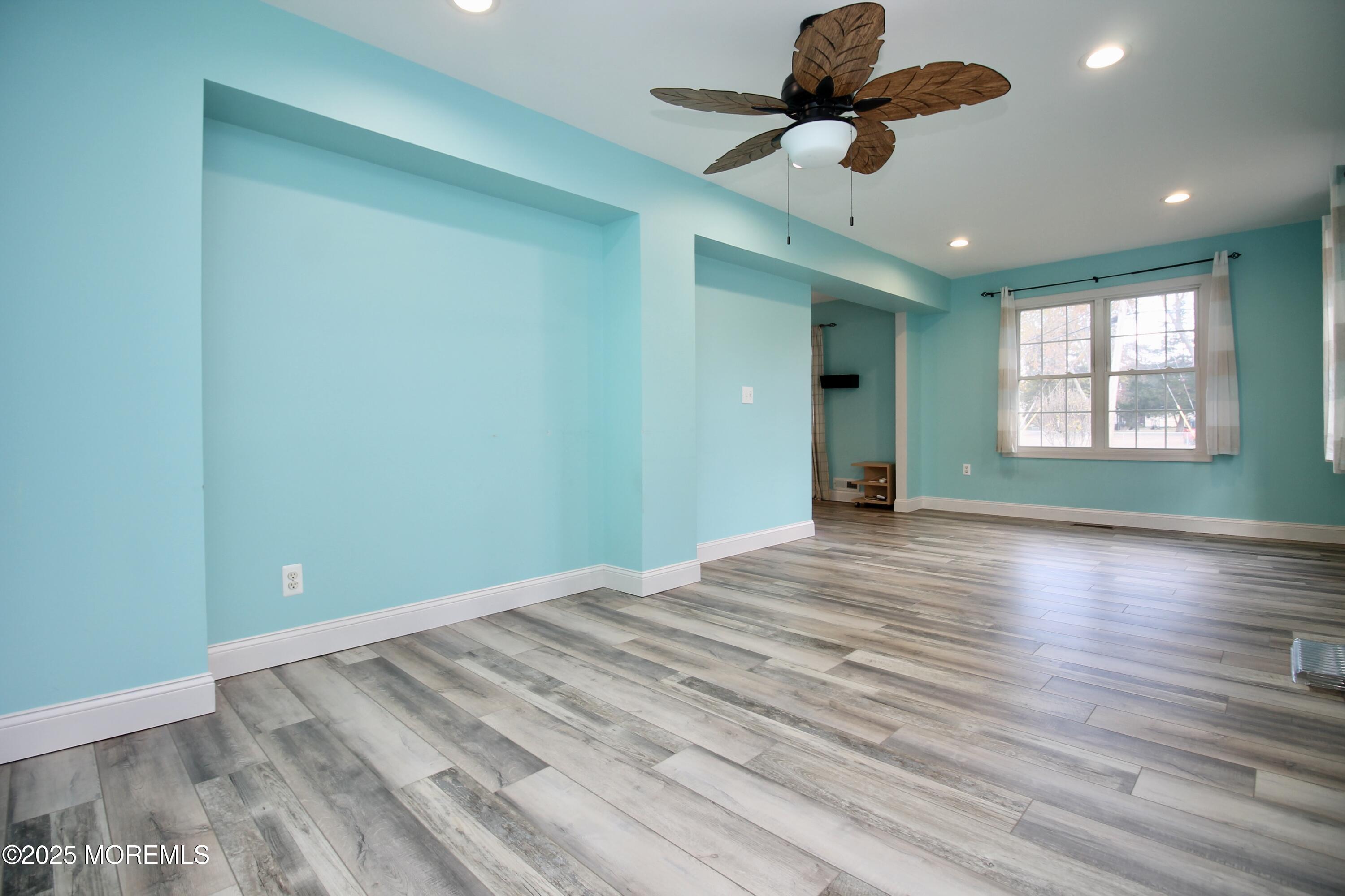 16 Maple Lane Howell, NJ 07731 - Photo 15 of 55 a view of empty room with wooden floor and fan