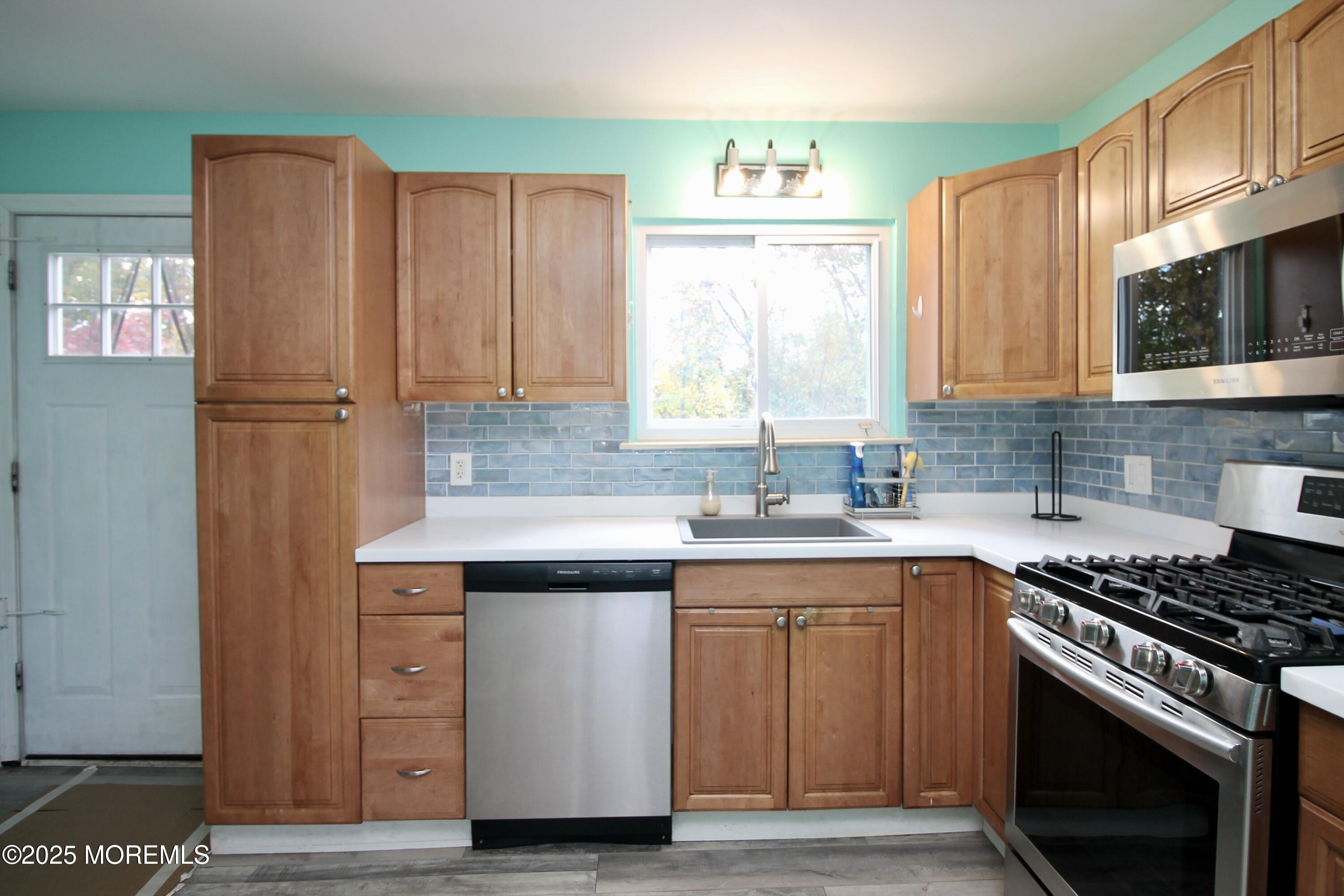 16 Maple Lane Howell, NJ 07731 - Photo 18 of 55 a kitchen with cabinets appliances and a window