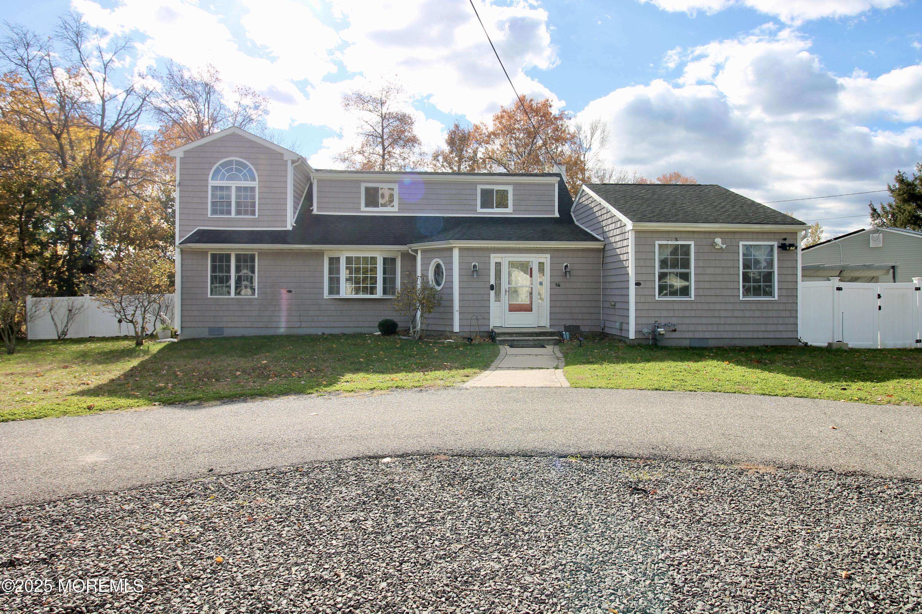 16 Maple Lane Howell, NJ 07731 - Photo 2 of 55 a front view of a house with a yard and large trees