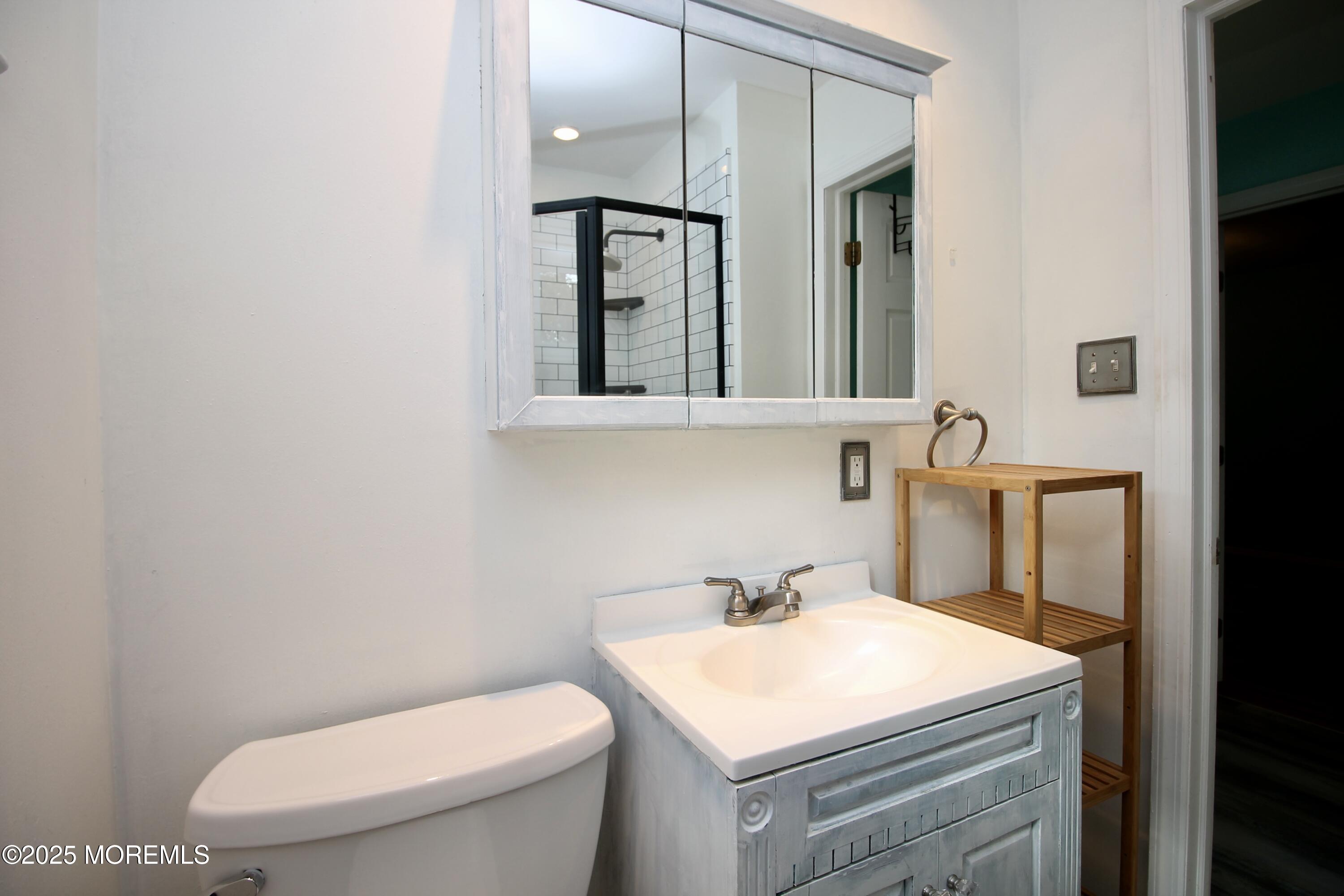 16 Maple Lane Howell, NJ 07731 - Photo 22 of 55 a bathroom with a toilet sink and mirror