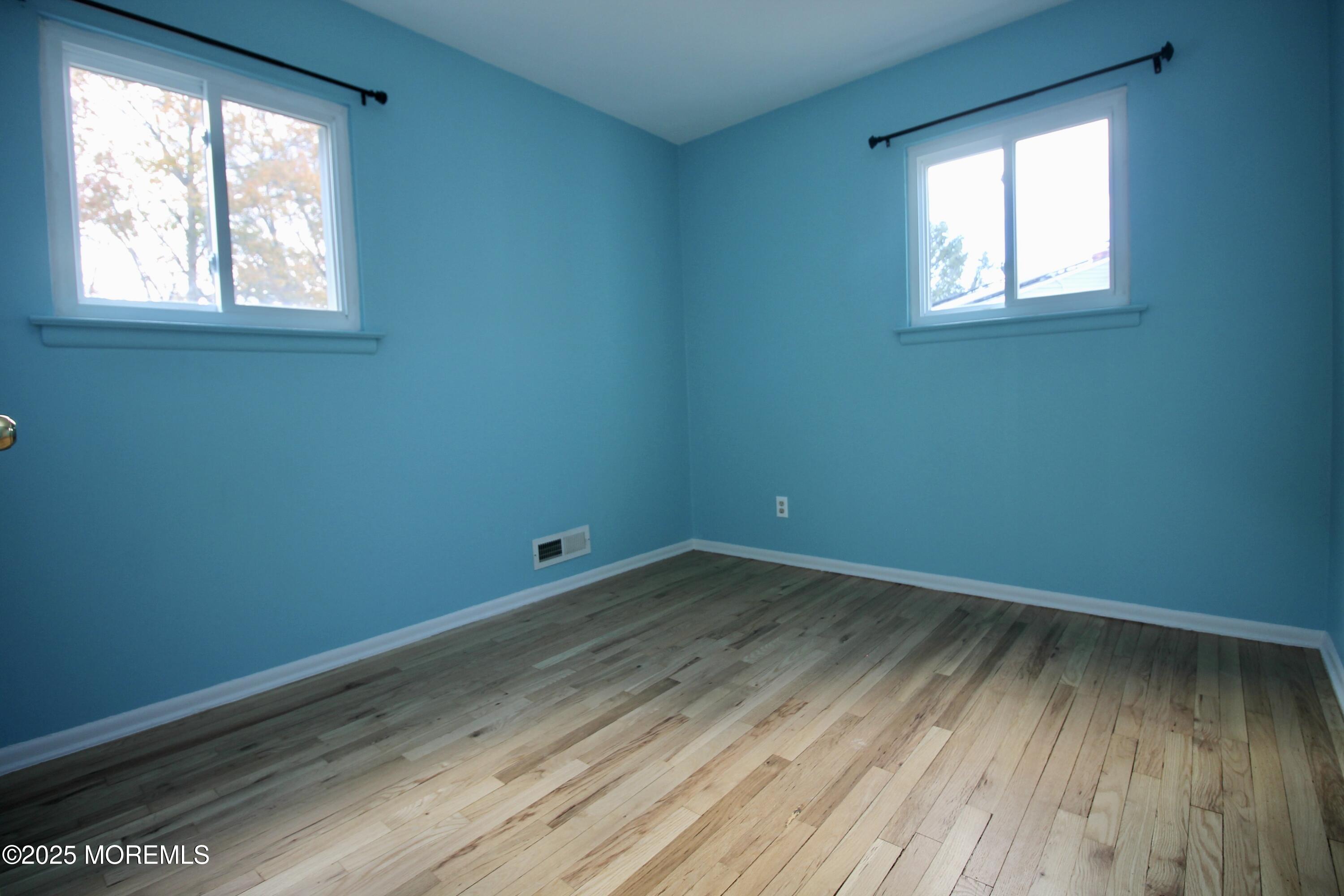 16 Maple Lane Howell, NJ 07731 - Photo 23 of 55 an empty room with wooden floor and windows