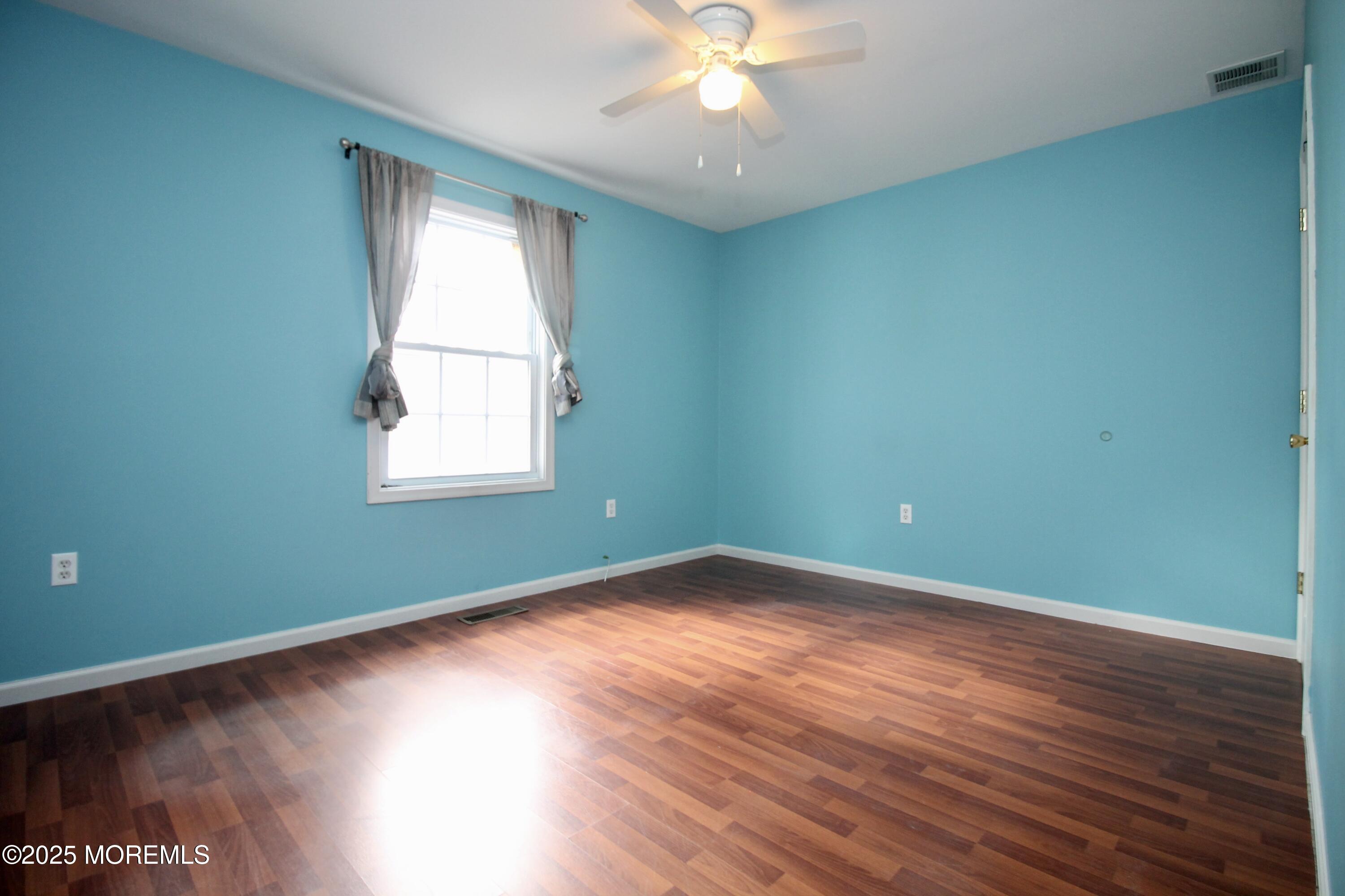16 Maple Lane Howell, NJ 07731 - Photo 25 of 55 an empty room with wooden floor and windows
