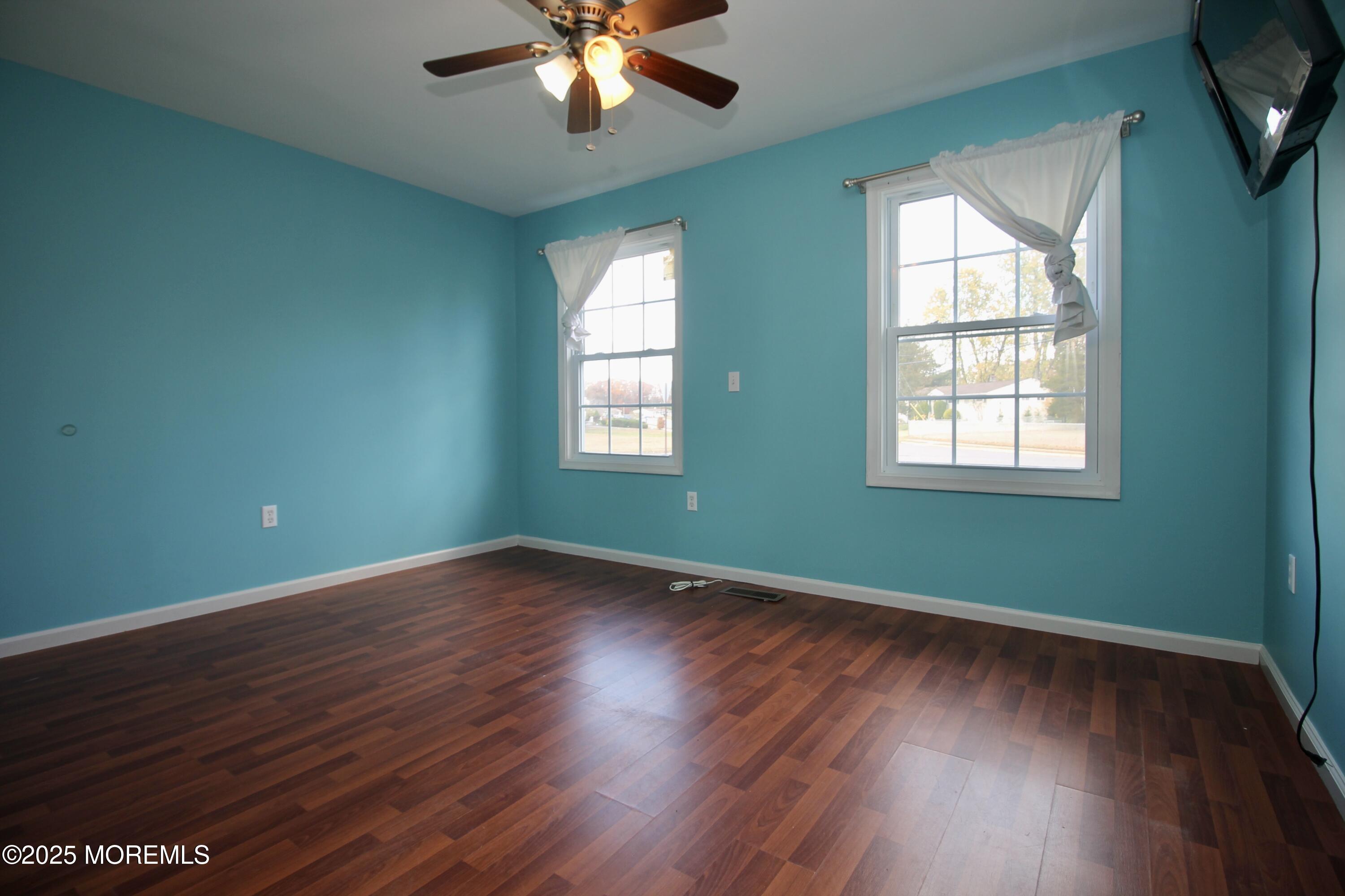 16 Maple Lane Howell, NJ 07731 - Photo 27 of 55 a view of an empty room with wooden floor and a window