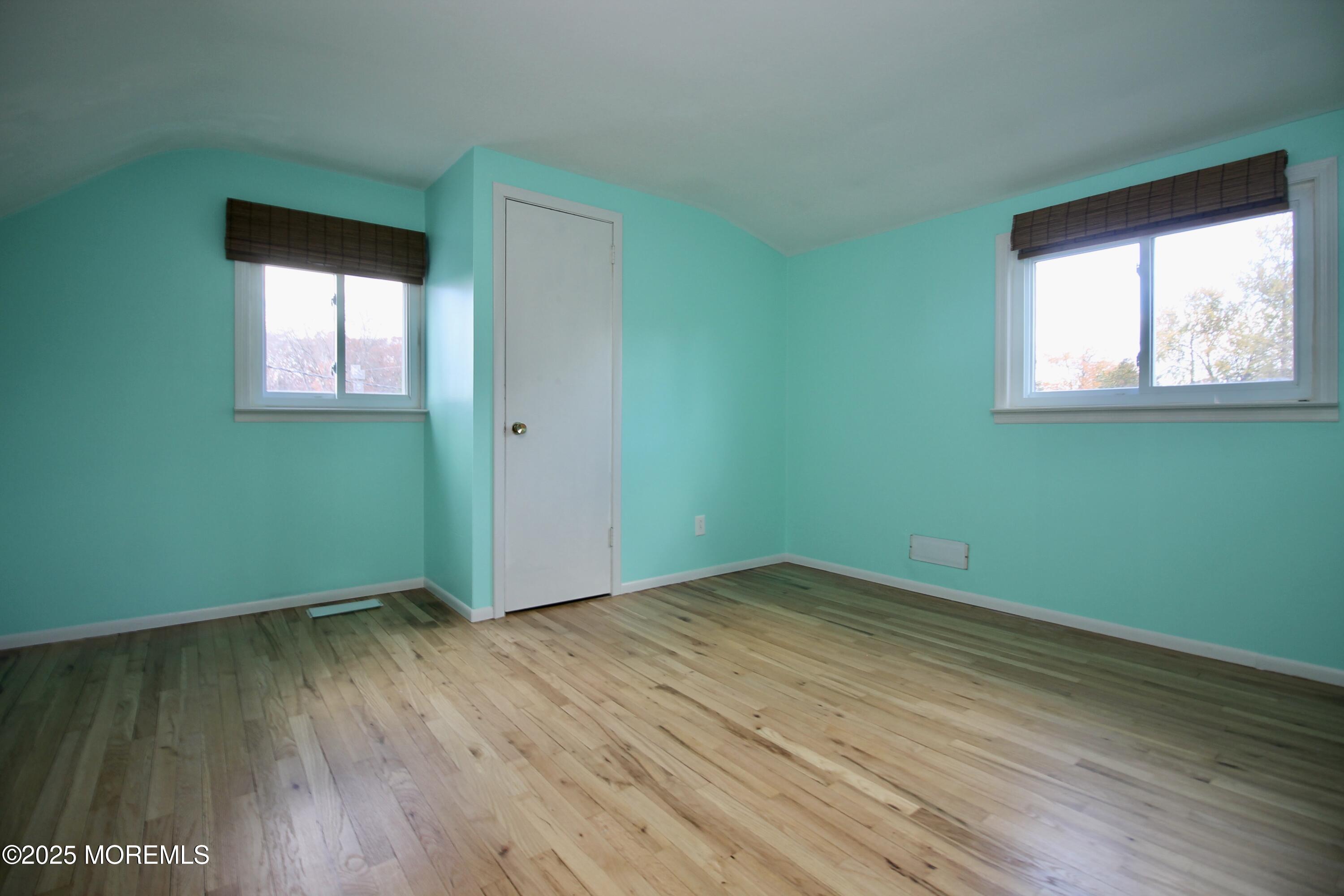 16 Maple Lane Howell, NJ 07731 - Photo 28 of 55 an empty room with wooden floor and windows