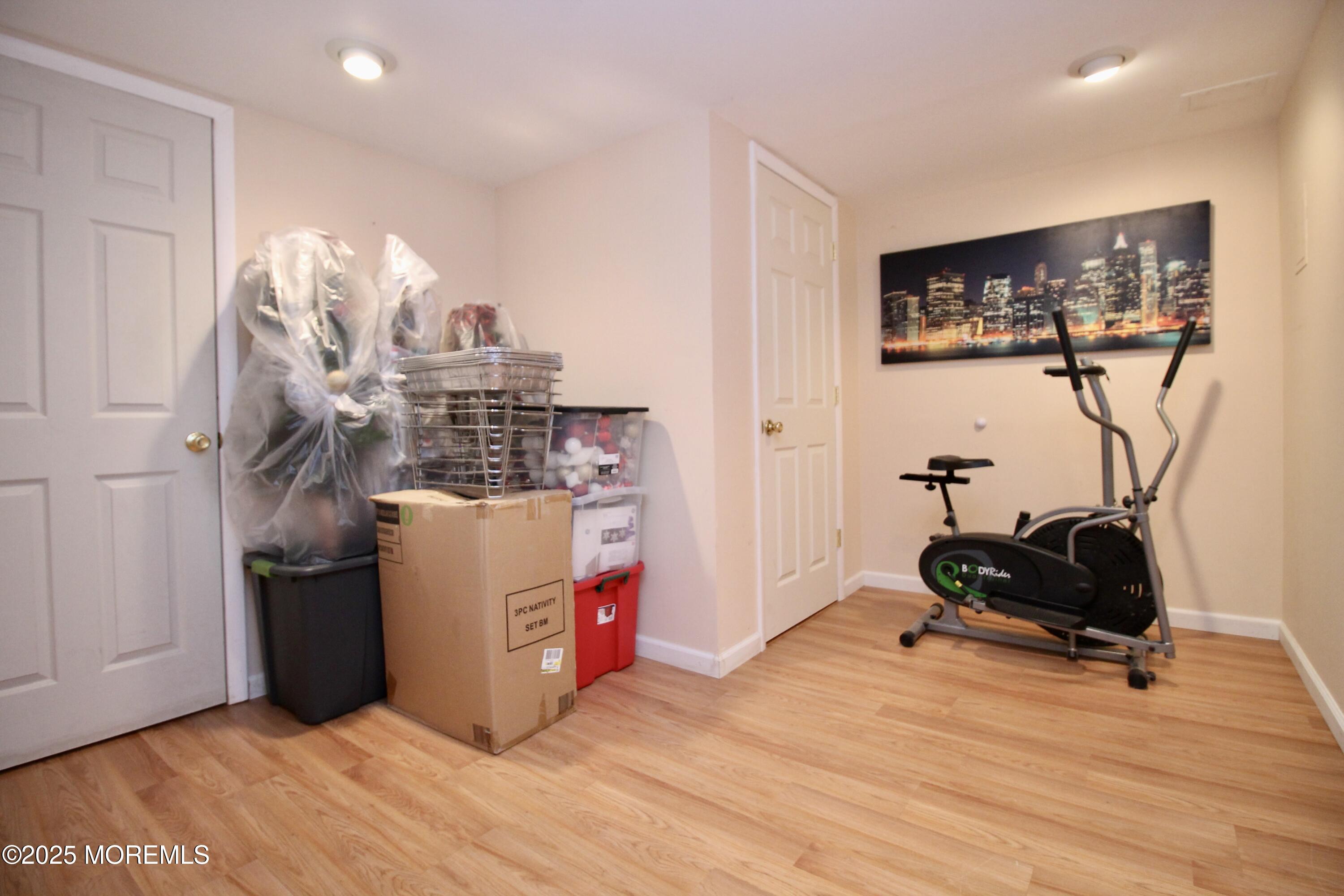 16 Maple Lane Howell, NJ 07731 - Photo 38 of 55 a room with a wooden floor and gym equipment