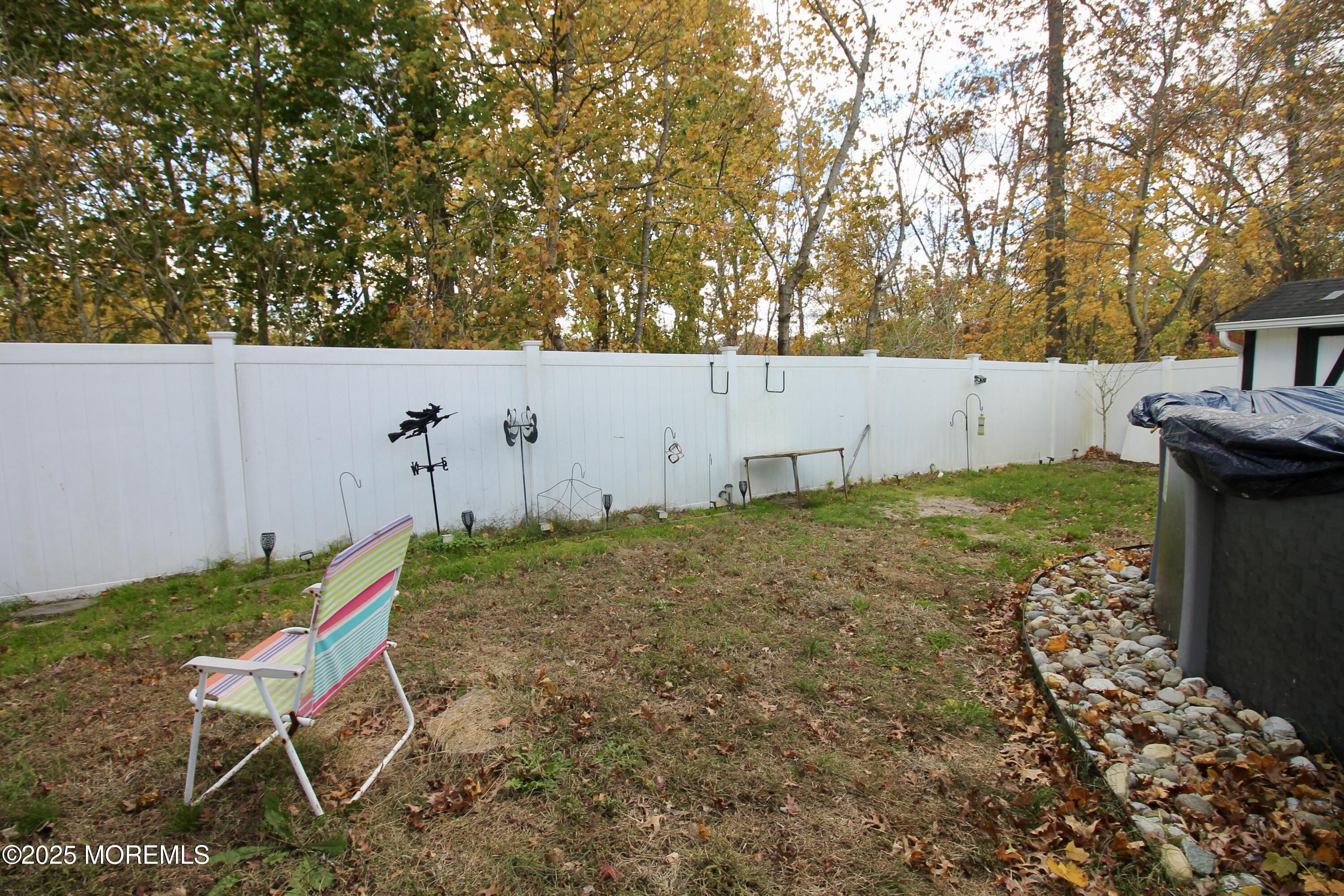 16 Maple Lane Howell, NJ 07731 - Photo 43 of 55 a backyard of a house with table and chairs