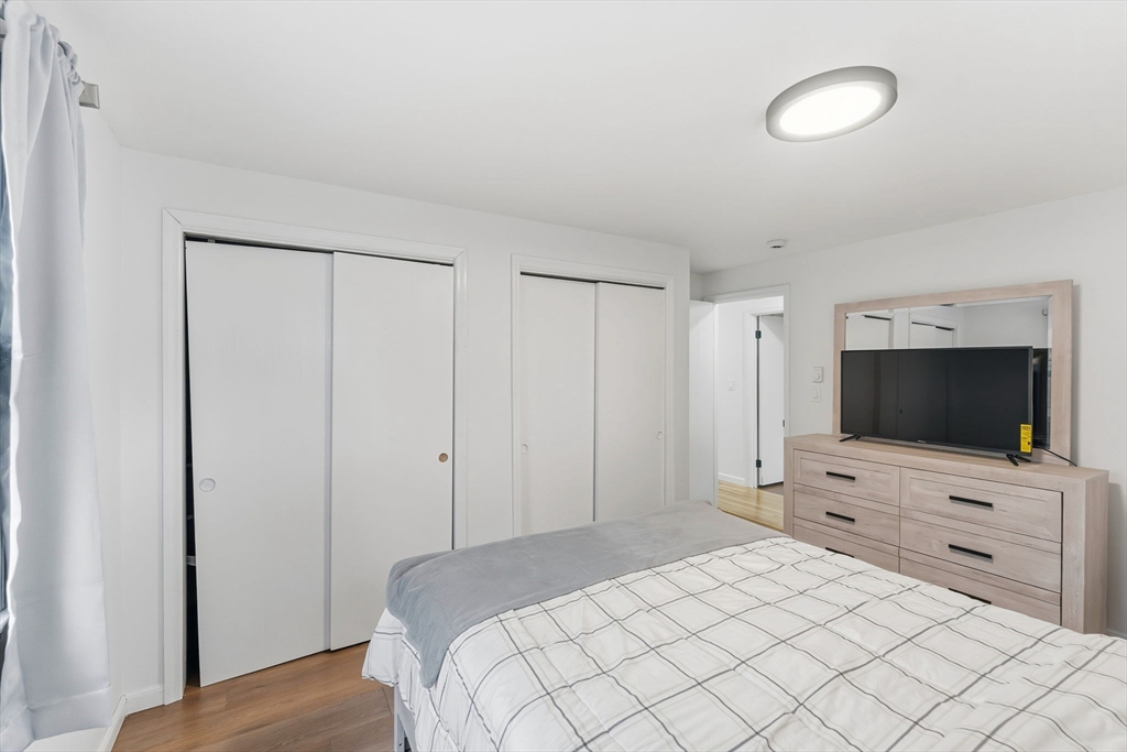 26 Wakefield Avenue Webster, MA 01570 - Photo 16 of 42 a hotel room with a flat screen tv and a lamp