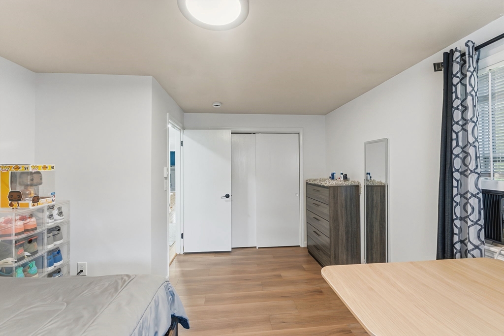 26 Wakefield Avenue Webster, MA 01570 - Photo 19 of 42 a bed room with a bed and a refrigerator