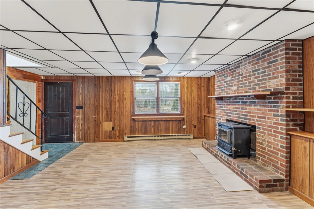 26 Wakefield Avenue Webster, MA 01570 - Photo 26 of 42 a front view of a house with wooden floor and fireplace