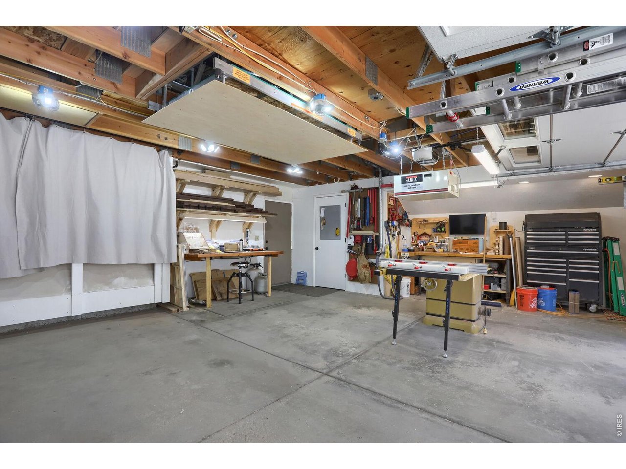 6010 Flagstaff Road Boulder, CO 80302 - Photo 33 of 41 Over size 2 car garage pushed out to the side for a workshop worth of tools, or toys, or dirt bikes. Note the electric lift at the ceiling to lift up any storage items you want to put in the 120 sqft of garage attic.