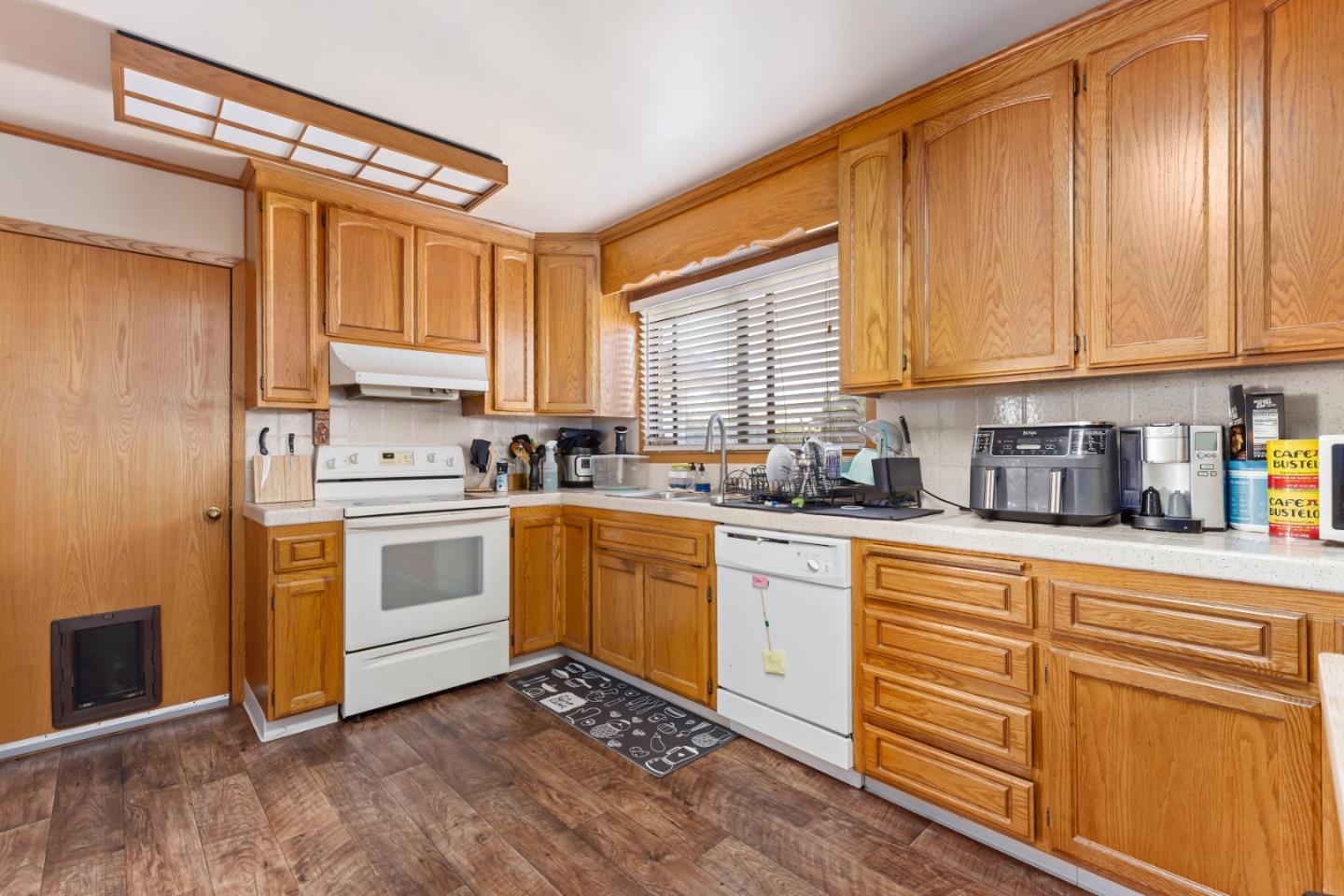 4563 Malabar Avenue Castro Valley, CA 94546 - Photo 6 of 19 a kitchen with granite countertop wooden cabinets a sink and white appliances