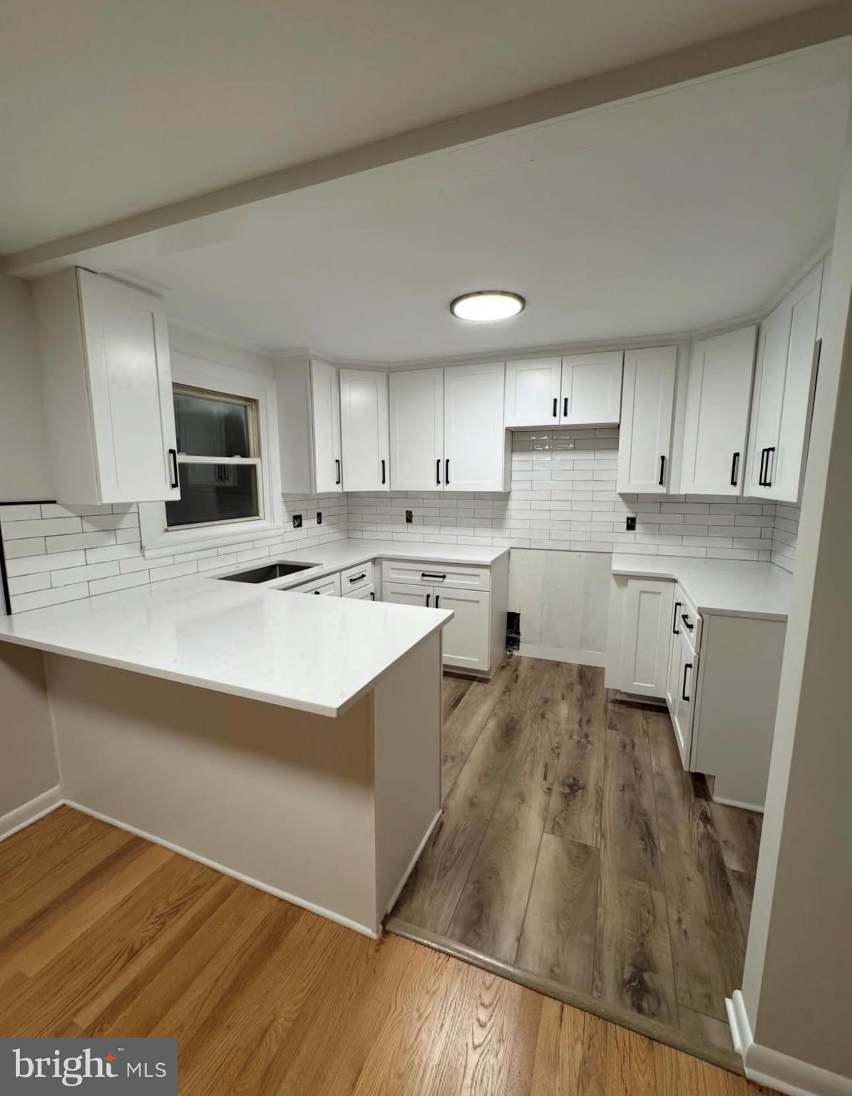 a kitchen with a stove a sink and a refrigerator