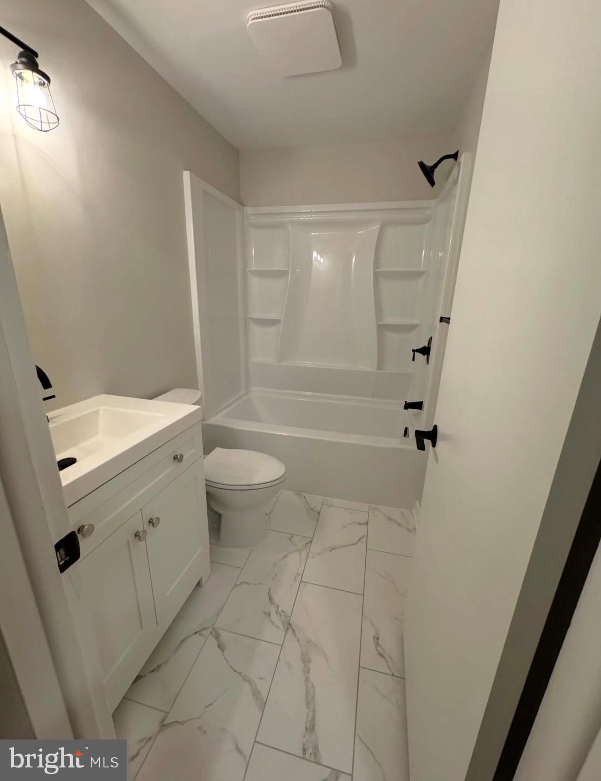 4 D Sterling Terrace, Unit D Stratford, NJ 08084 - Photo 2 of 8 a bathroom with a granite countertop sink toilet and shower