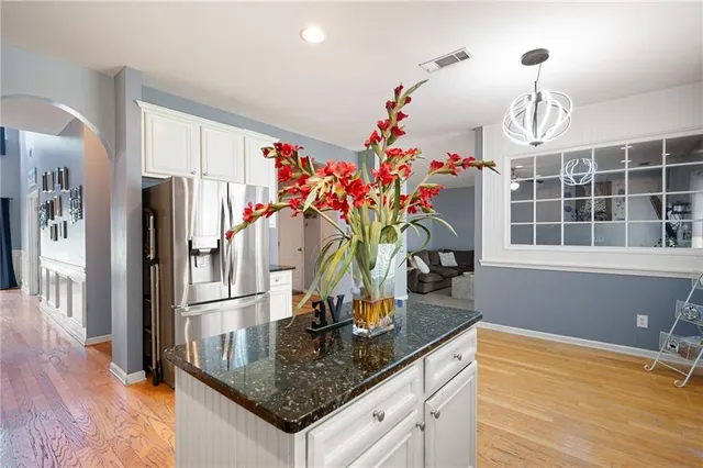 a kitchen with stainless steel appliances granite countertop a sink refrigerator and microwave