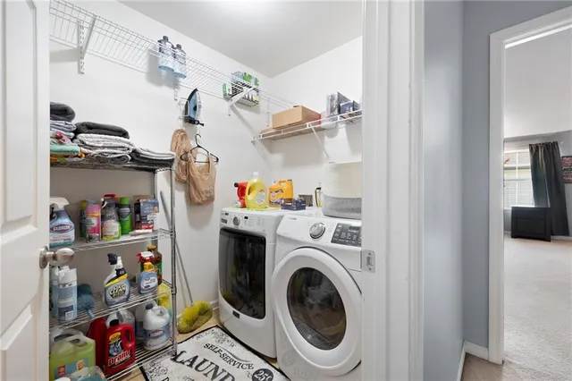 a utility room with fridge dryer and washer