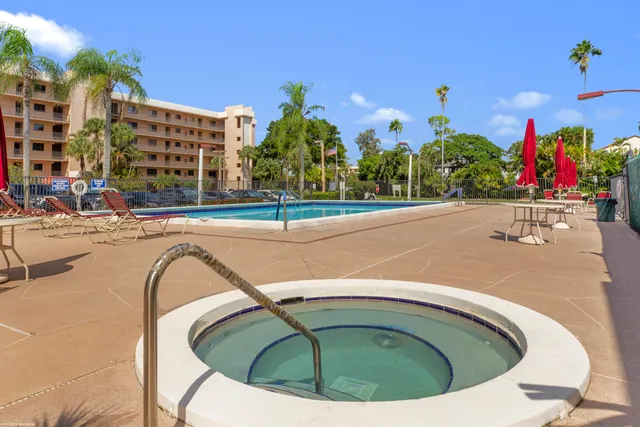 a view of a house with swimming pool and sitting area