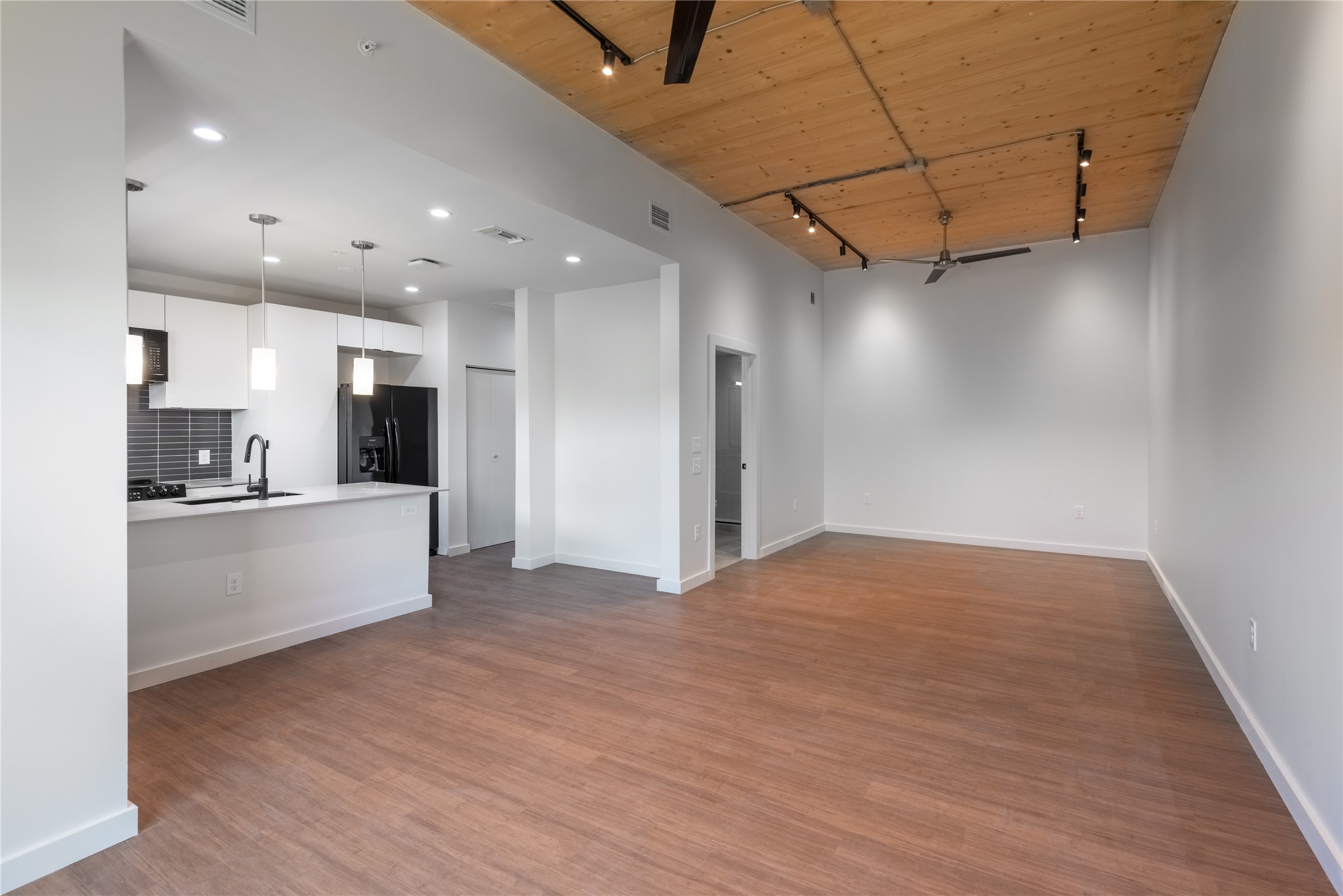 3515 Webberville Road, Unit VISTA Austin, TX 78702 - Photo 7 of 22 a kitchen with stainless steel appliances kitchen island granite countertop a refrigerator and a sink