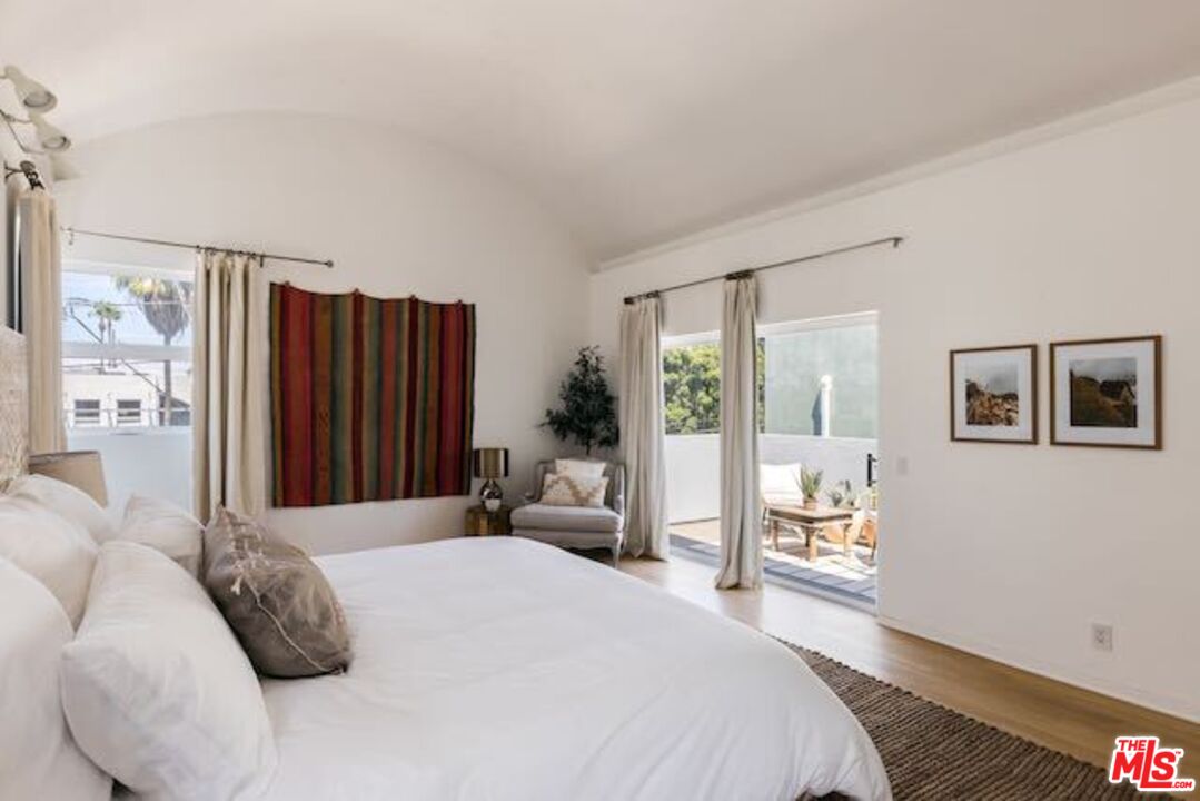1523 Cabrillo Avenue Venice, CA 90291 - Photo 12 of 22 a bedroom with a large bed and a large window
