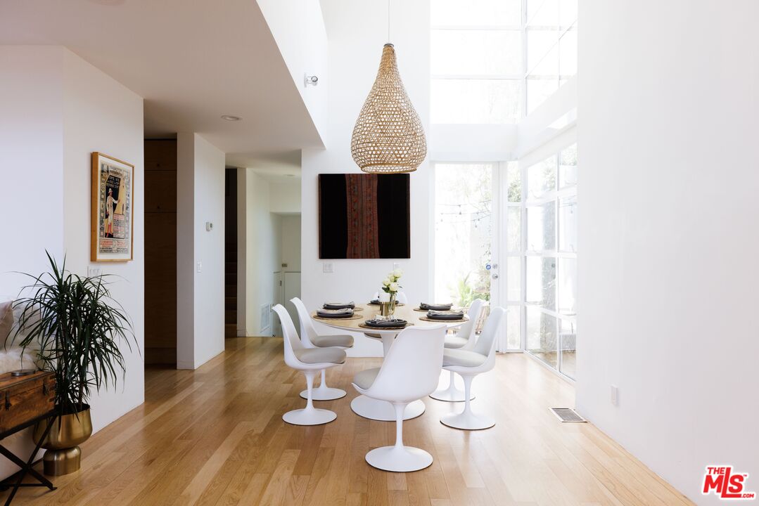 1523 Cabrillo Avenue Venice, CA 90291 - Photo 5 of 22 a dining room with wooden floor a glass table and chairs