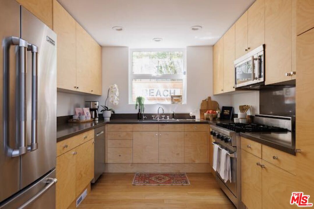 1523 Cabrillo Avenue Venice, CA 90291 - Photo 10 of 22 a kitchen with granite countertop a sink stainless steel appliances and cabinets