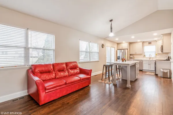 a view of a livingroom with furniture window and wooden floor