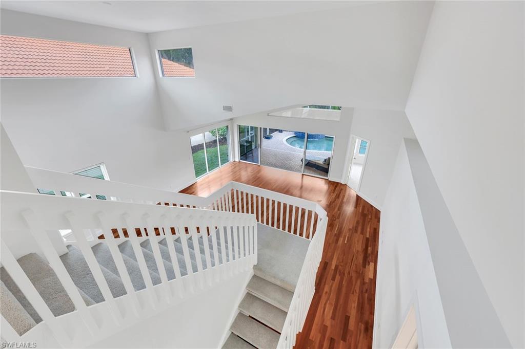 123 Napa Ridge Way Naples, FL 34119 - Photo 12 of 30 a bedroom with furniture and wooden floor