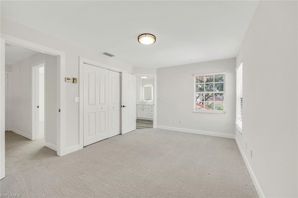 123 Napa Ridge Way Naples, FL 34119 - Photo 18 of 30 a view of an empty room with a window
