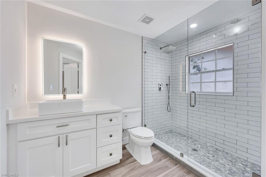 123 Napa Ridge Way Naples, FL 34119 - Photo 20 of 30 a bathroom with a sink a toilet and shower