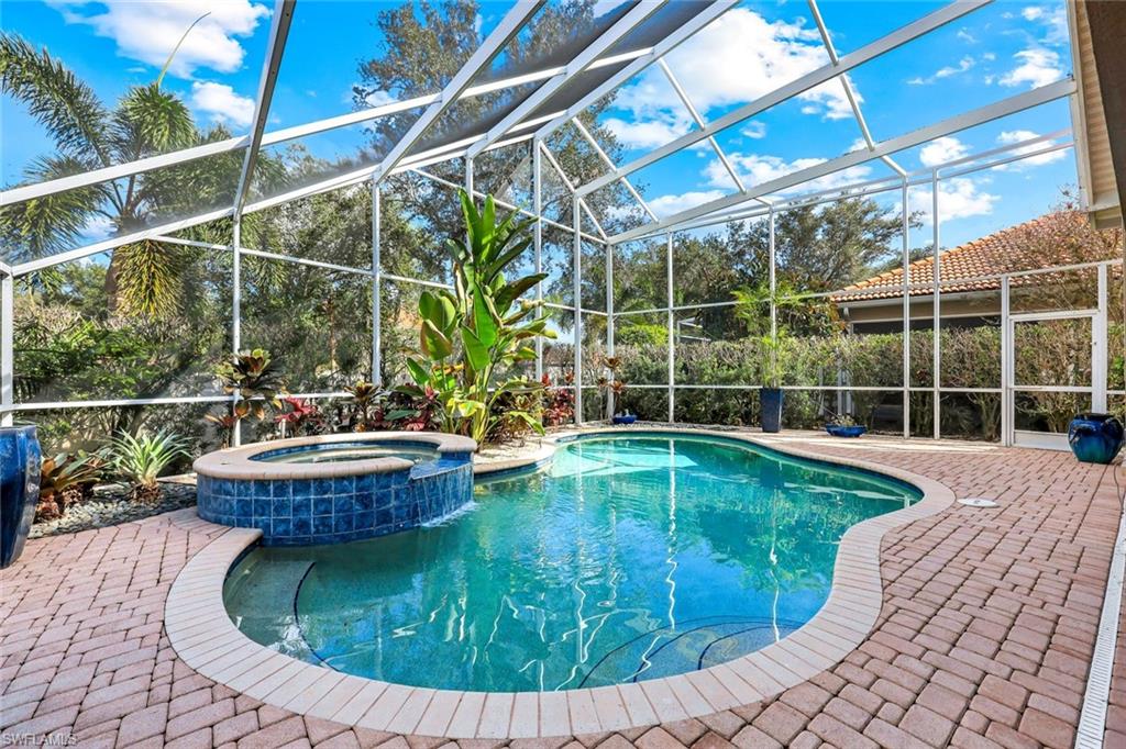 123 Napa Ridge Way Naples, FL 34119 - Photo 24 of 30 a view of a swimming pool with a patio