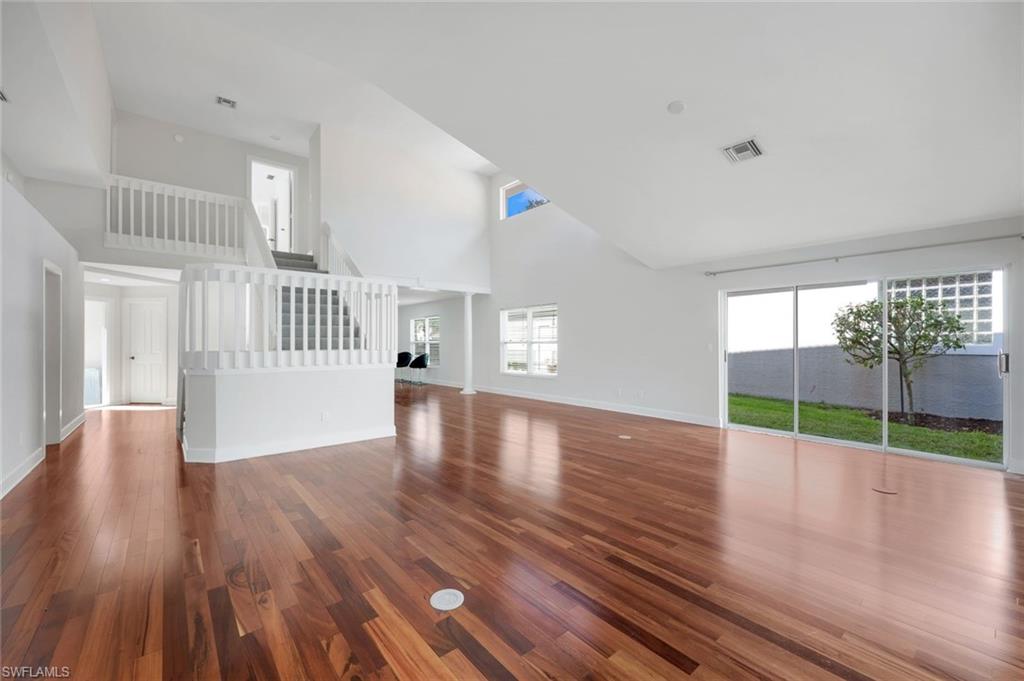 123 Napa Ridge Way Naples, FL 34119 - Photo 7 of 30 a view of empty room with wooden floor and fan