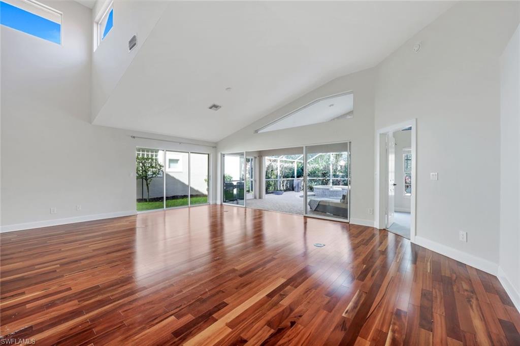 123 Napa Ridge Way Naples, FL 34119 - Photo 8 of 30 a view of dining room with wooden floor