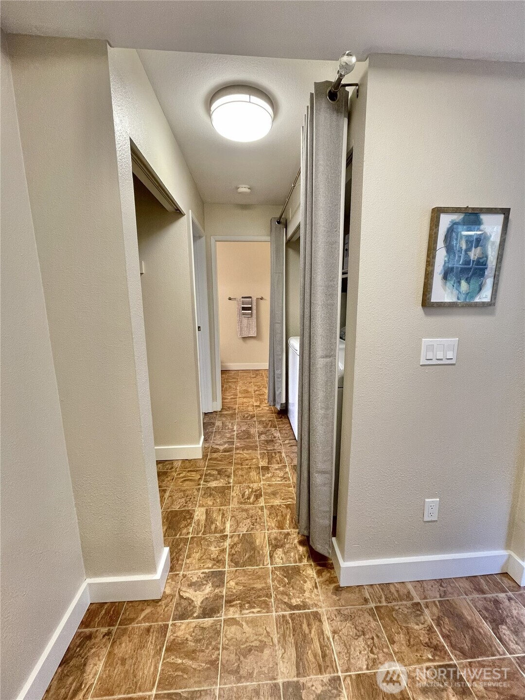 5300 Harbour Pointe Boulevard, Unit 311H Mukilteo, WA 98275 - Photo 14 of 27 a view of a hallway with wooden floor and a bathroom
