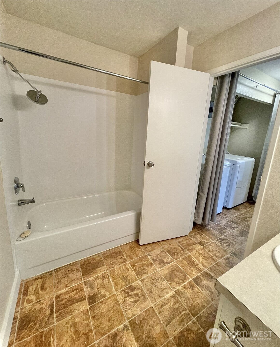 5300 Harbour Pointe Boulevard, Unit 311H Mukilteo, WA 98275 - Photo 20 of 27 a bathroom with a bathtub and a shower