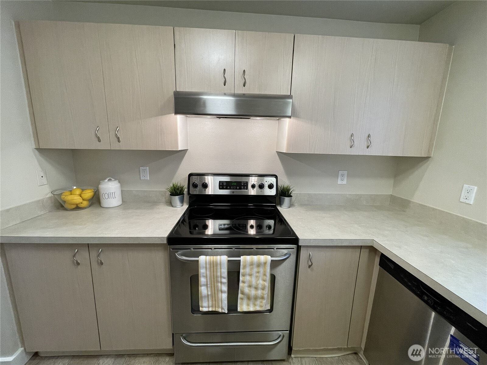 5300 Harbour Pointe Boulevard, Unit 311H Mukilteo, WA 98275 - Photo 6 of 27 a kitchen with white cabinets and appliances