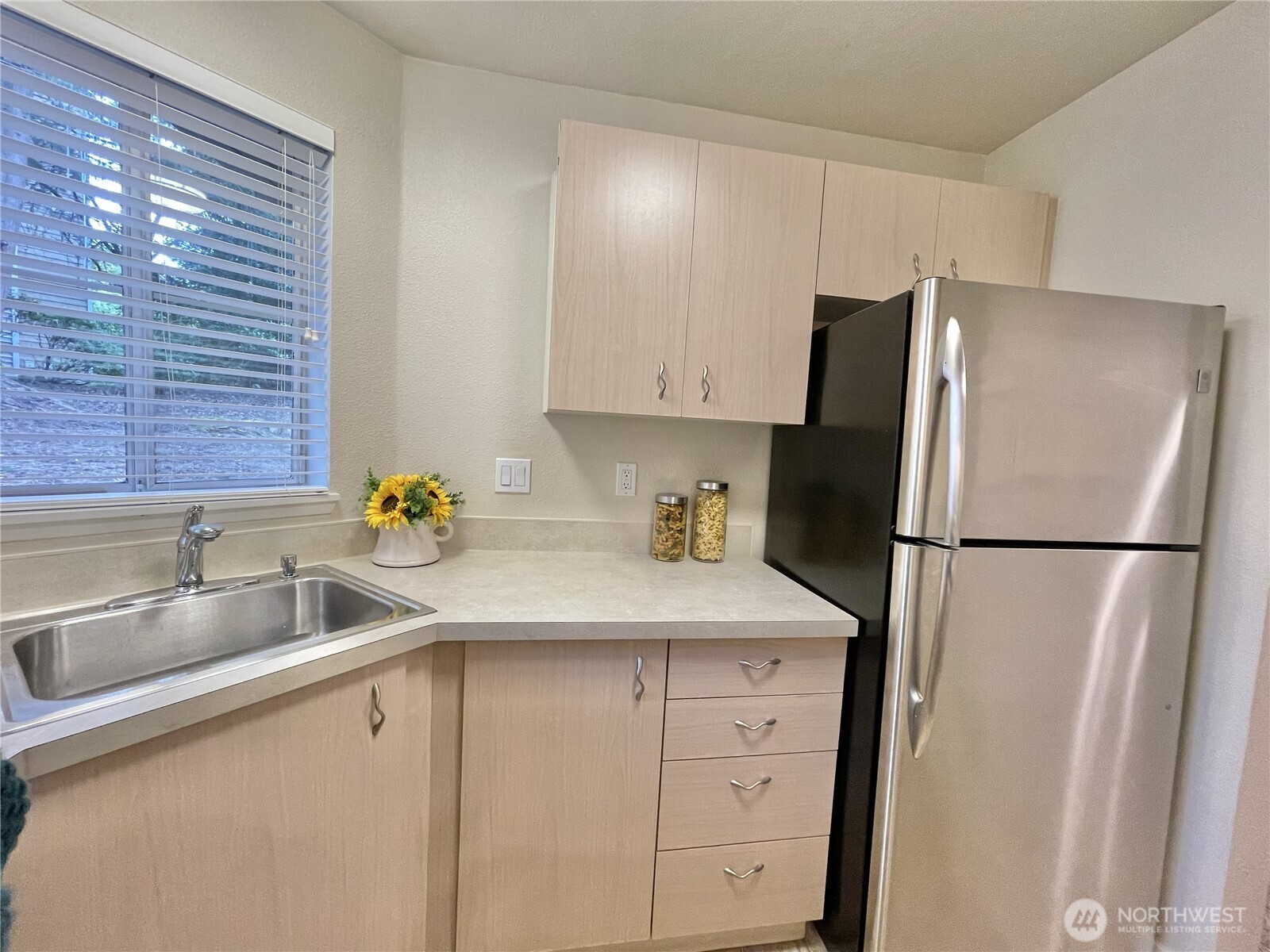 5300 Harbour Pointe Boulevard, Unit 311H Mukilteo, WA 98275 - Photo 7 of 27 a kitchen with a refrigerator sink and cabinets